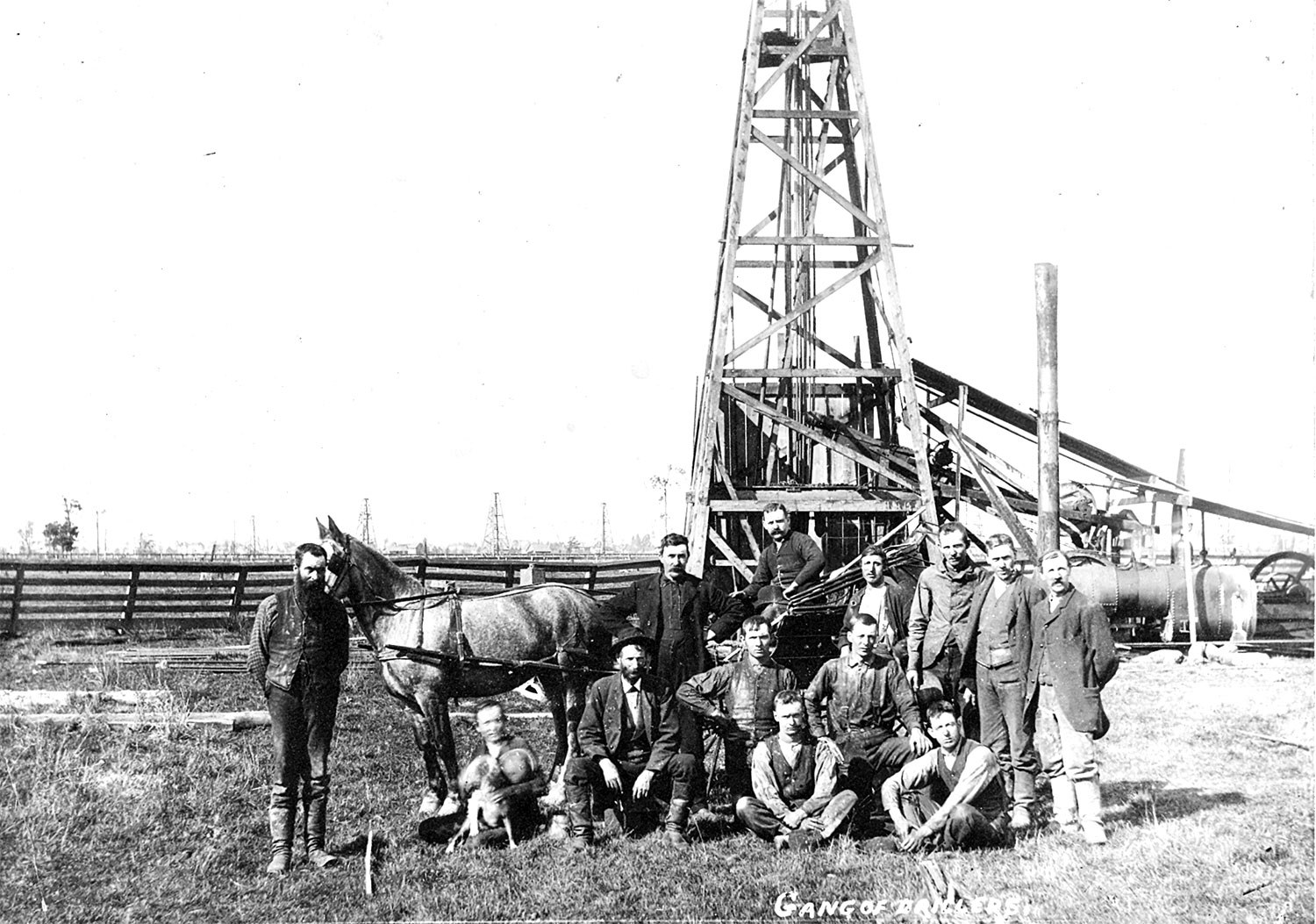A drill crew at Petrolia in 1910, standing before their steam-powered drilling rig